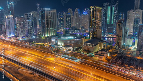 Dubai Marina skyscrapers and Sheikh Zayed road with metro railway aerial night timelapse  United Arab Emirates