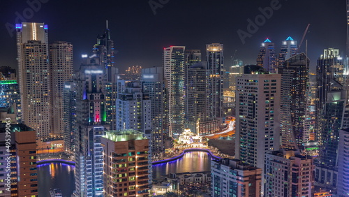 Dubai Marina skyline with Mohammad Bin Ahmed Al Mulla mosque aerial timelapse at night. © neiezhmakov