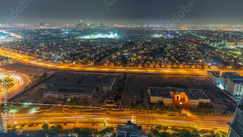 Aerial view to villas and houses from JLT district night timelapse.