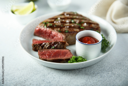 Grilled beef steak with tomato sauce