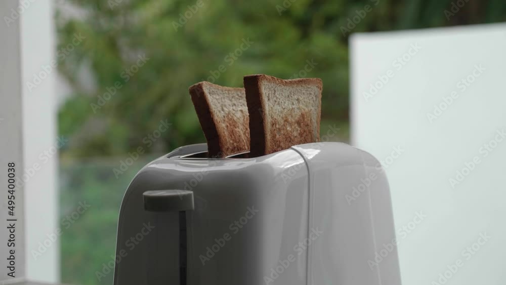 Sent From Toaster Roasted toast bread popping up from toaster machine while smoke comes ...