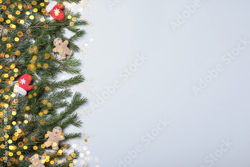 Christmas greeting card with space for text. Flat lay composition of fir tree branches and festive decor on white background