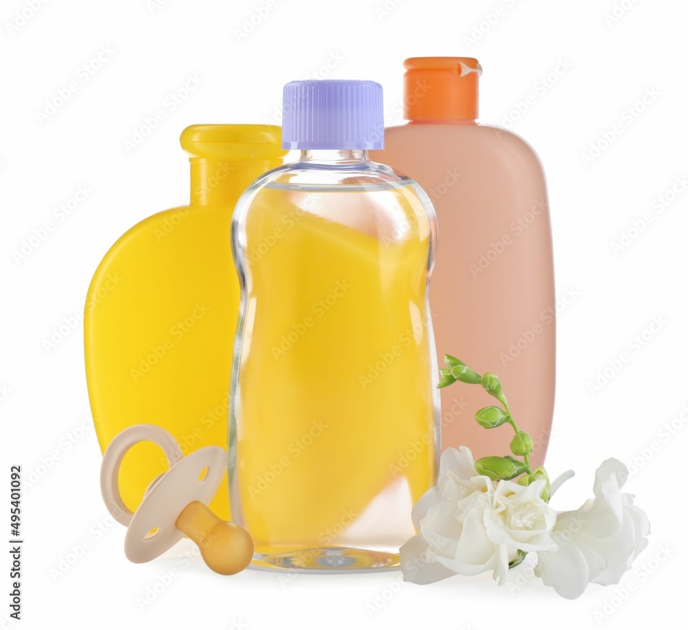 Baby oil, toiletries, pacifier and flowers on white background Baby oil, toiletries, pacifier and flowers on white background