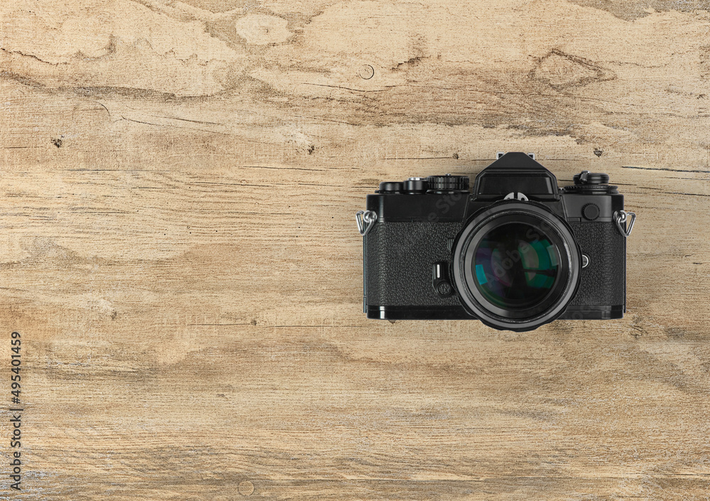 photographic camera on wooden background