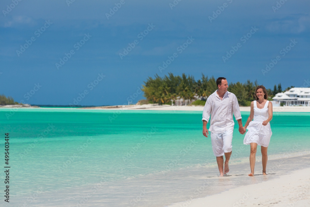 Happy Caucasian couple on tropical beach resort outdoors