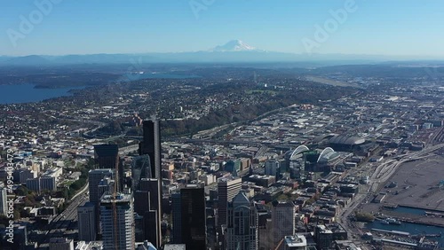 High up aerial view of Seattle's skyscrapers and industrial district with Mount Rainier on the horizon. photo