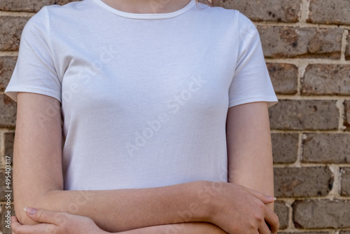 Wallpaper Mural Girl wearing mockup white t-shirt on brick wall background. Template copy space Torontodigital.ca