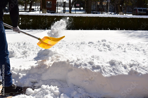 clearing snow by hand with a shovel