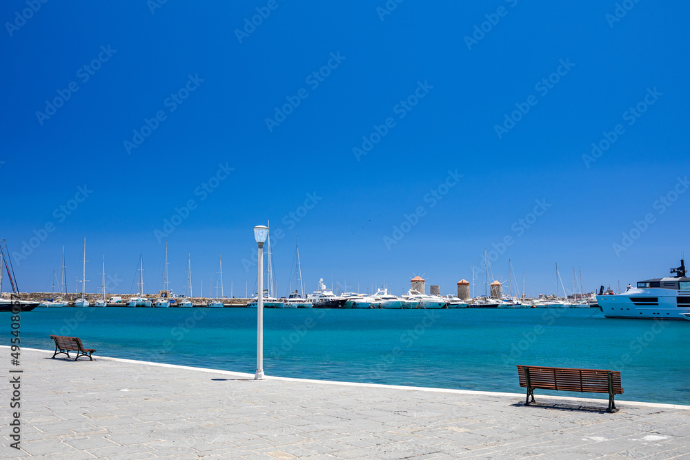 Rhodes Windmills in the Mandraki harbor and marina. Sightseeing in the old town. Rhodes, Greece