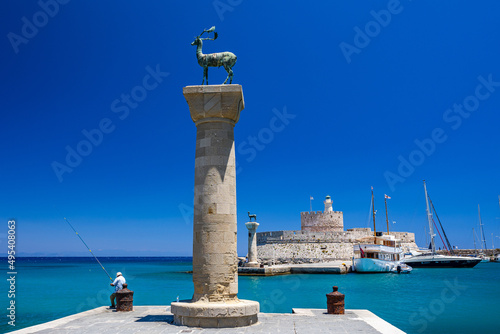 Entrance to Mandraki harbor and marina. Hirsch and Hirschkuh, Elafos and Elafina, bronze statues of deer and stags in the place of the Colossus of Rhodes. Sightseeing in the old town. Rhodes, Greece