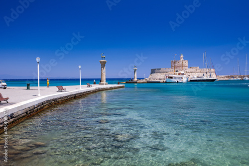 Entrance to Mandraki harbor and marina. Hirsch and Hirschkuh, Elafos and Elafina, bronze statues of deer and stags in the place of the Colossus of Rhodes. Sightseeing in the old town. Rhodes, Greece