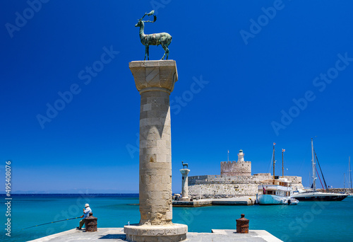 Entrance to Mandraki harbor and marina. Hirsch and Hirschkuh, Elafos and Elafina, bronze statues of deer and stags in the place of the Colossus of Rhodes. Sightseeing in the old town. Rhodes, Greece