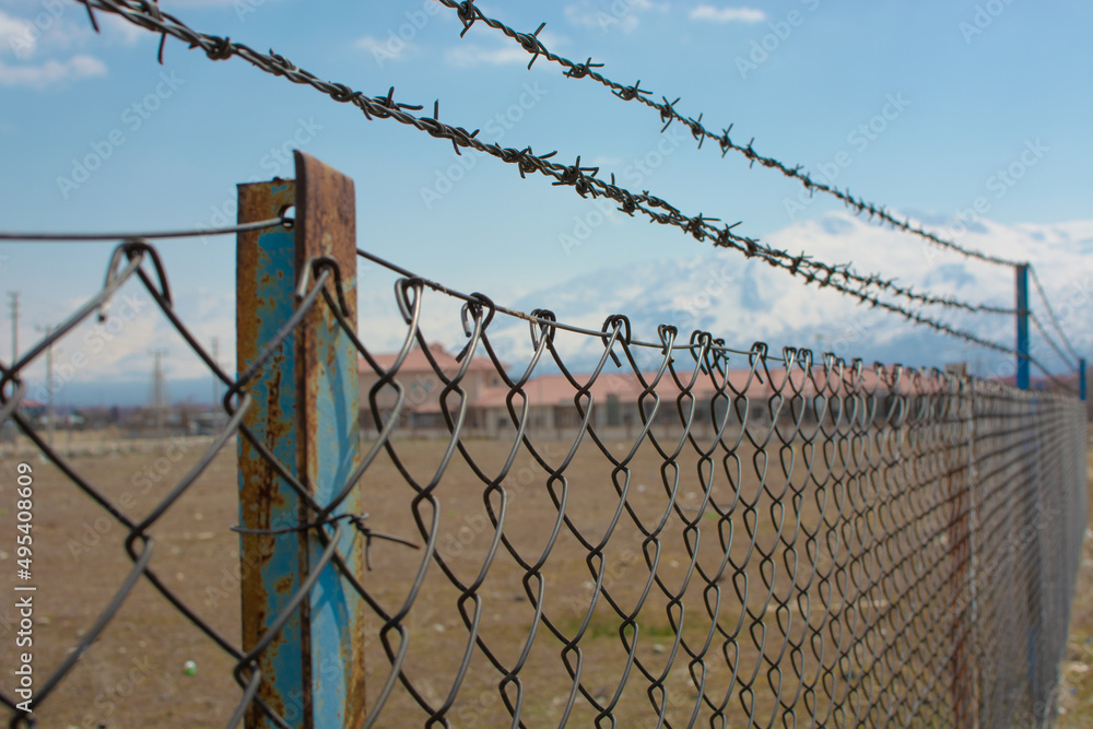 A prison surrounded by barbed wire. Captivity themed photo. A prison surrounded by barbed wire. Captivity themed photo.