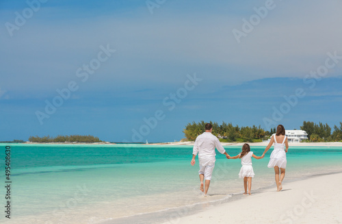 Photography Happy family with daughter walking aquamarine shallows barefoot