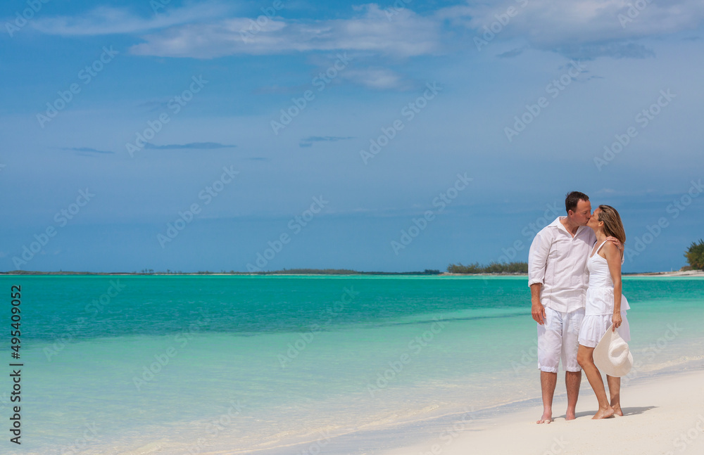Loving Caucasian couple sharing closeness on beach holiday Loving Caucasian couple sharing closeness on beach holiday