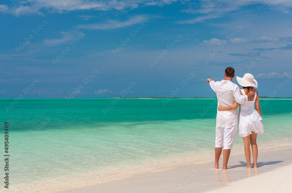 Loving Caucasian couple on beach by the sea Loving Caucasian couple on beach by the sea