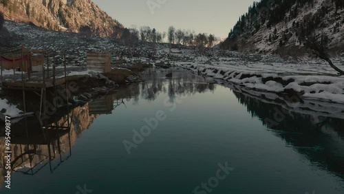 Aerial view of a river in between the mountains covered with snow at Swat valley, Pakistan photo