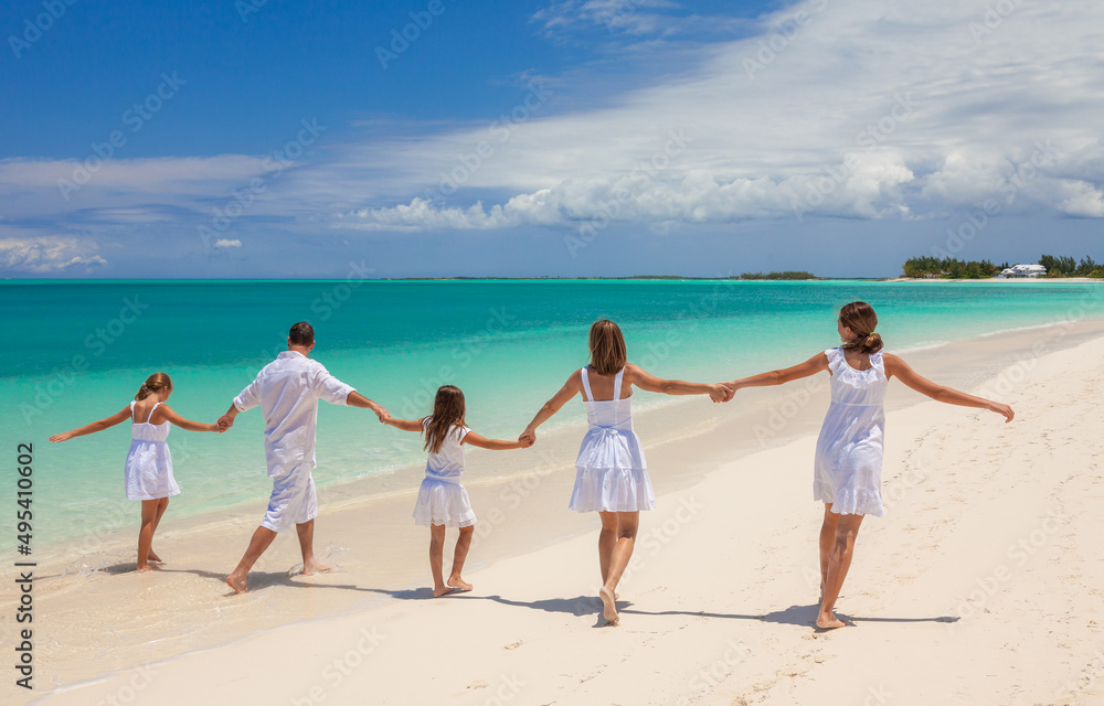 Young Caucasian parents and children beach fun together