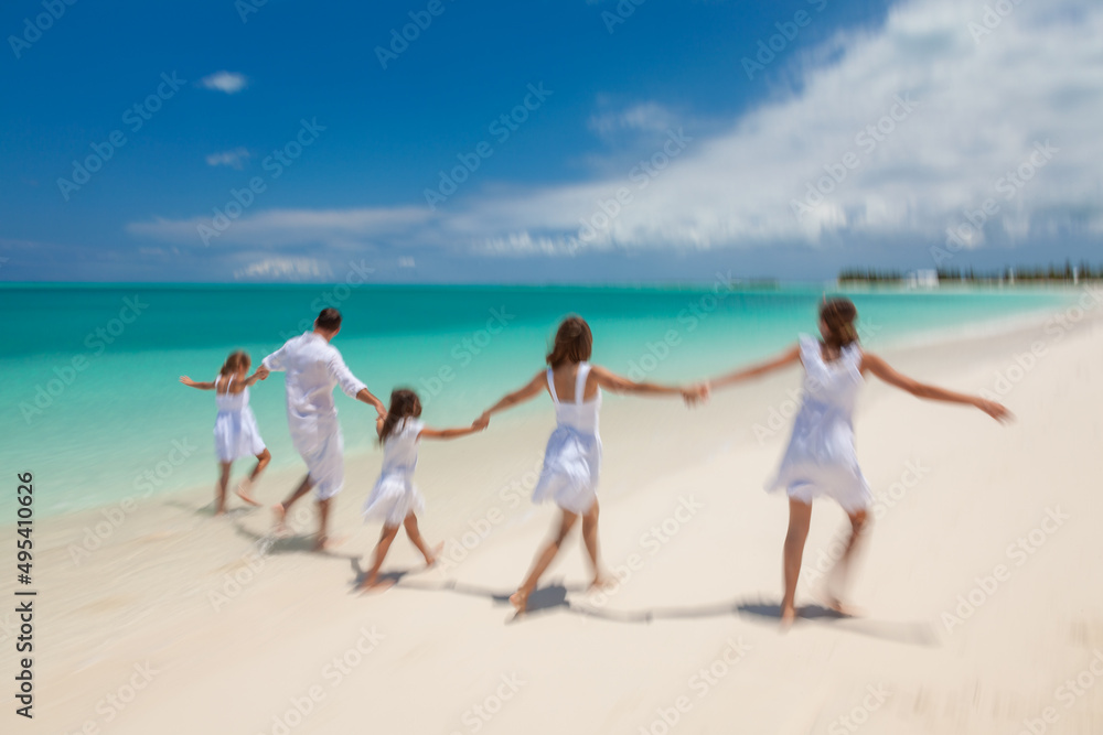 Young Caucasian parents and children beach fun together Young Caucasian parents and children beach fun together