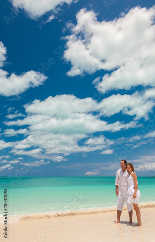 Happy Caucasian couple romantic closeness by tropical ocean