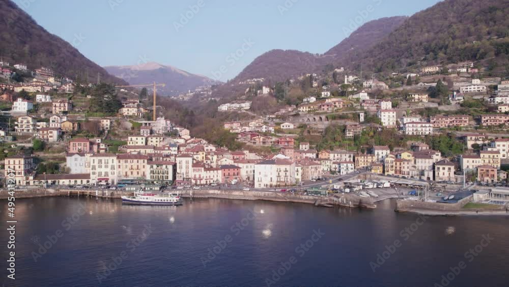 Aerial slide view of Argegno city on Lake Como with a boat on the dock. Aerial slide view of Argegno city on Lake Como with a boat on the dock.