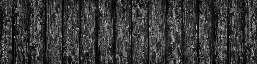 Black rough wooden board wide banner texture. Old knotty wood plank large widescreen background. Dark gloomy grunge backdrop Black rough wooden board wide banner texture. Old knotty wood plank large widescreen background. Dark gloomy grunge backdrop