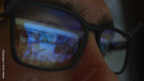 Wallpaper Mural Man with glasses is watching content Internet, reflection monitor glass. Torontodigital.ca