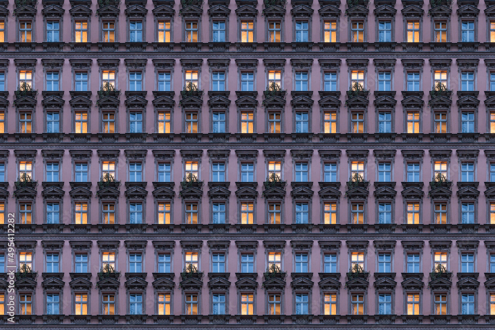 architectural pattern, beautiful pink facade of a berlin old building with illuminated windows architectural pattern, beautiful pink facade of a berlin old building with illuminated windows