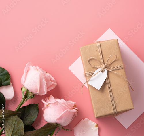 Mother's Day design concept background with pink rose flower and gift on pink background.
