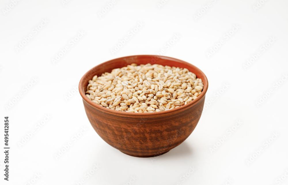 Barley groats in bowls and bags isolated on a white background. High quality photo Barley groats in bowls and bags isolated on a white background. High quality photo