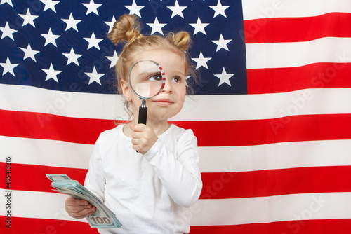 Little beautiful girl with American dollarsi the hands, Flag of America