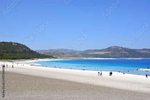 Salda lake in Turkey with white sand and sky blue water and mountains and clear sky on background
