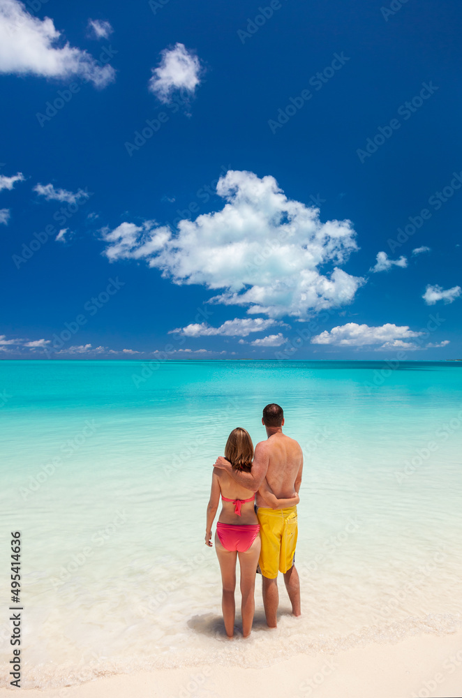 Male and female couple barefoot on beach Caribbean