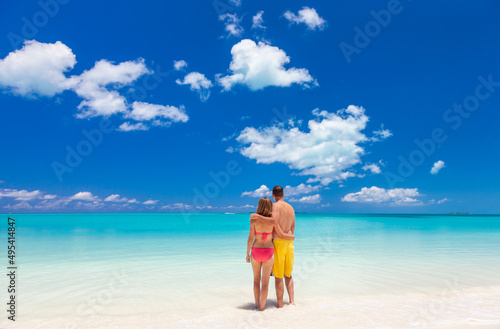 Happy Caucasian couple together on beach holiday Caribbean