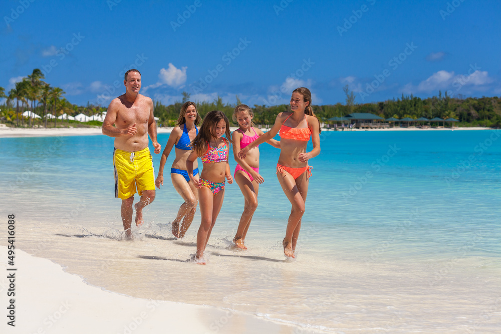 Caucasian family on tropical beach enjoying leisure Caribbean