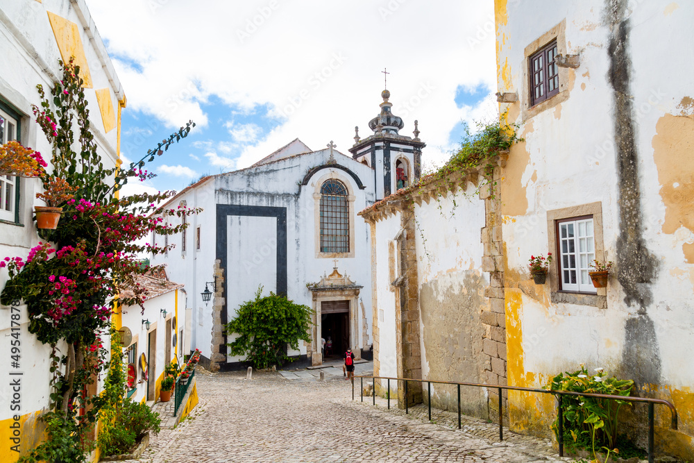 Beautiful street of Óbidos and Saint Peter church