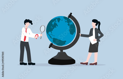 Exploring new location for investment, increasing customer base, or expanding business concept. Businesswoman and businessman try to pin investment base location on mock globe.  
