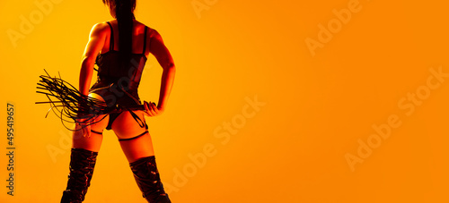 Canvas Print Studio shot of sexy young woman wearing leather lingerie posing isolated on yellow background in neon light
