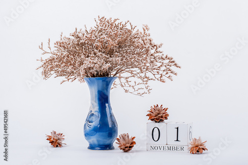 wooden calendar and a vase of flowers in the office. November 1 photo