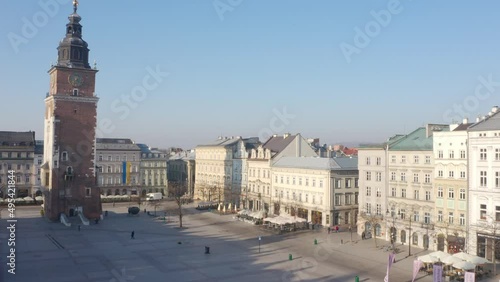 Town Hall Tower in Krakow Poland. Aerial view from above. Main Square Rynek Główny. Morning sunny soft light. Drove photo from above. symbol of the city’s power and prestige. Ukrainiane flage  photo