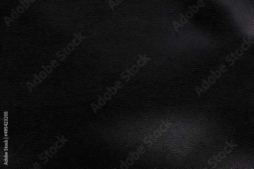 Black textured smooth leather surface background, small grain