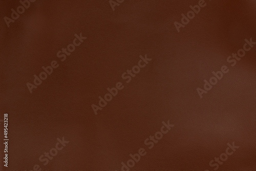 Chestnut textured smooth leather surface background, small grain