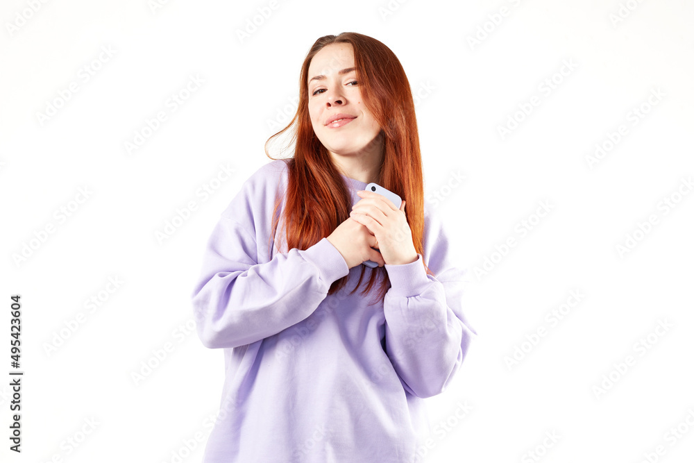 Caucasian woman in violet sweatshirt. Natural look. Smiling. long red hair. White background Caucasian woman in violet sweatshirt. Natural look. Smiling. long red hair. White background