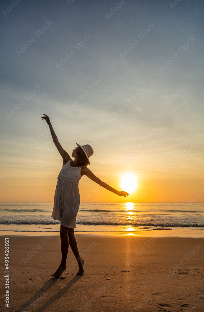 Happy Afro American girl dancing on sunset beach