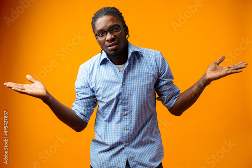 Tablou pe pânză Young afrcian man isolated on yellow background showing helpless gesture