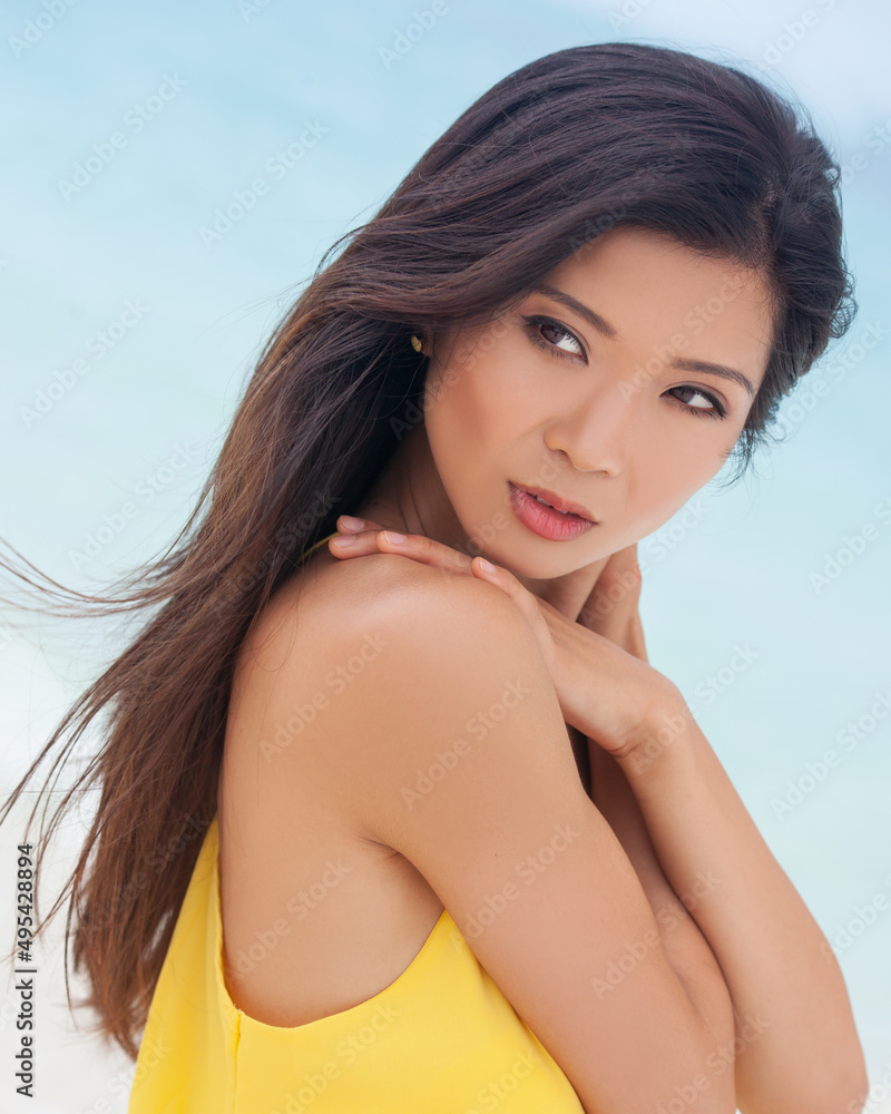 Beautiful young Asian girl wearing yellow Summer clothing Beautiful young Asian girl wearing yellow Summer clothing