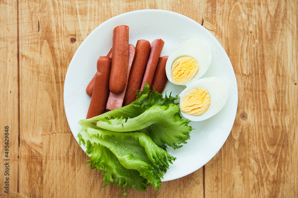 Beef franks, boiled eggs and green goods Frillice on plat Beef franks, boiled eggs and green goods Frillice on plat