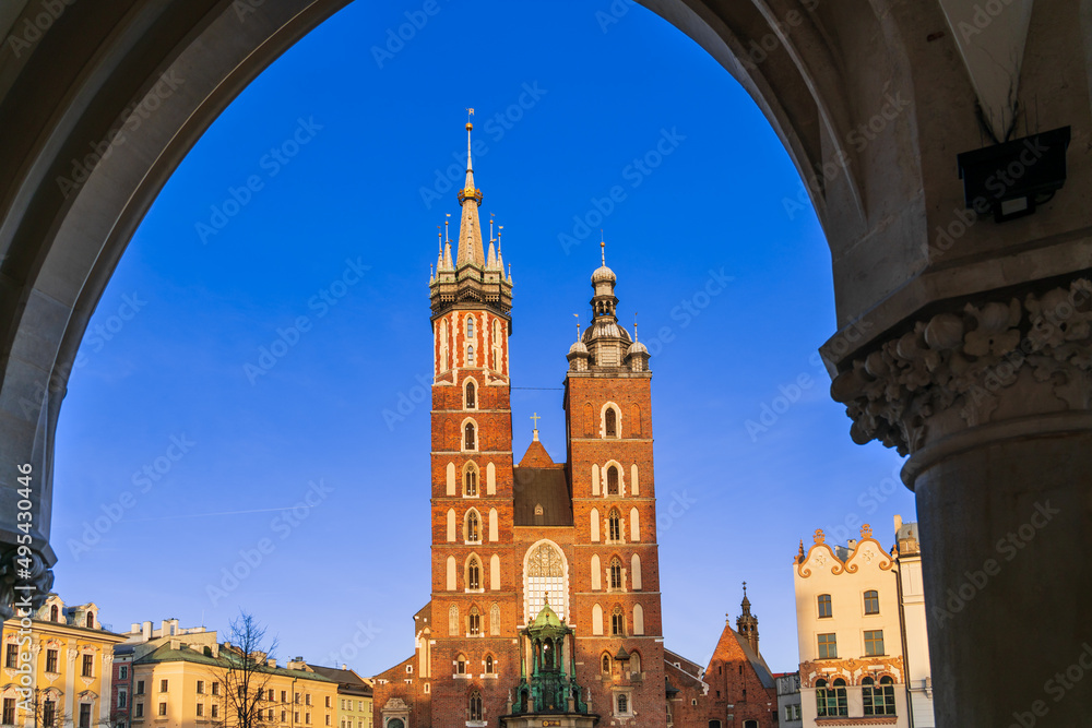 Basilica of St. Mary in the archway at sunset on the main market square in Krakow, Poland