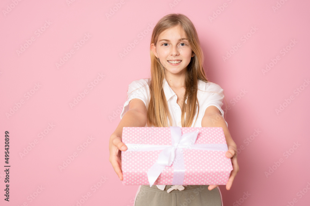 Picture of happy little girl standing isolated over pink background. Looking camera holding gift box surprise. Picture of happy little girl standing isolated over pink background. Looking camera holding gift box surprise.