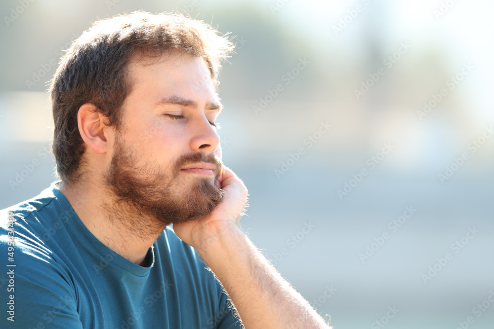 Fototapeta premium Relaxed man resting outdoors with closed eyes